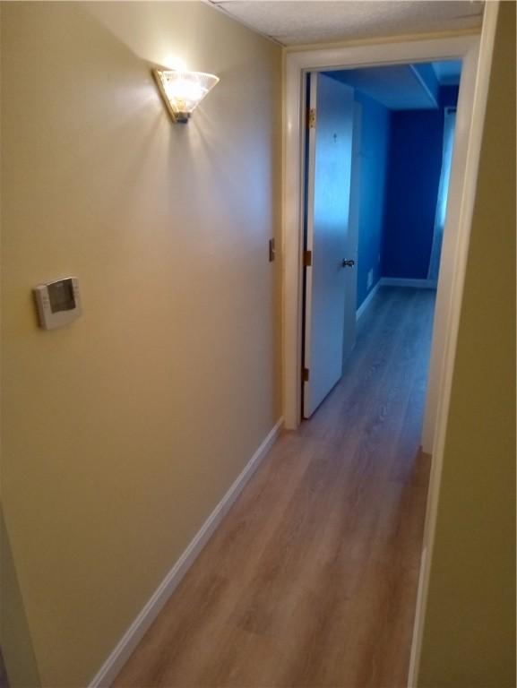 510 Child St Unit 106C, Warren, RI 02885 - hall with light wood-type flooring and baseboards