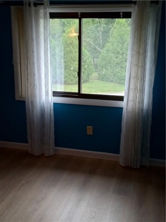 510 Child St Unit 106C, Warren, RI 02885 - spare room featuring wood finished floors and healthy amount of natural light