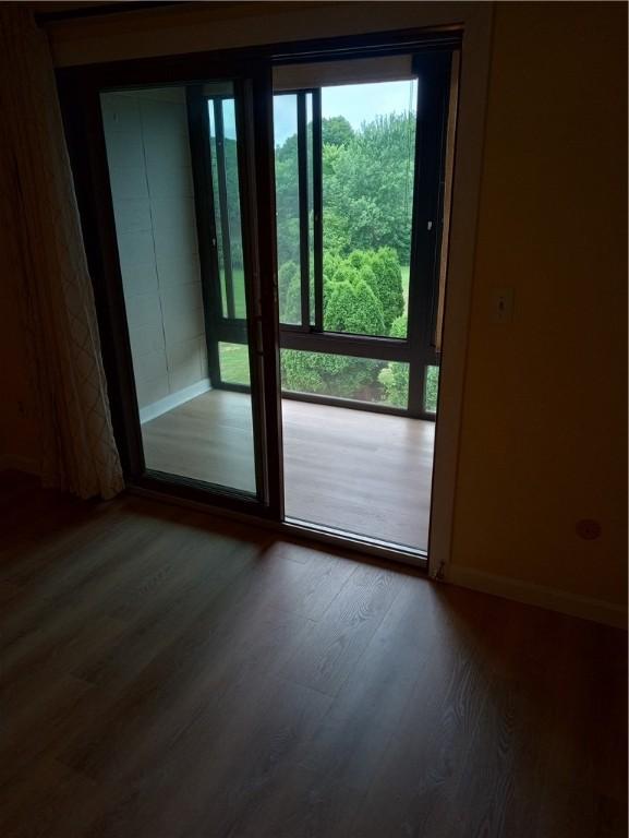 510 Child St Unit 106C, Warren, RI 02885 - doorway featuring wood finished floors and baseboards