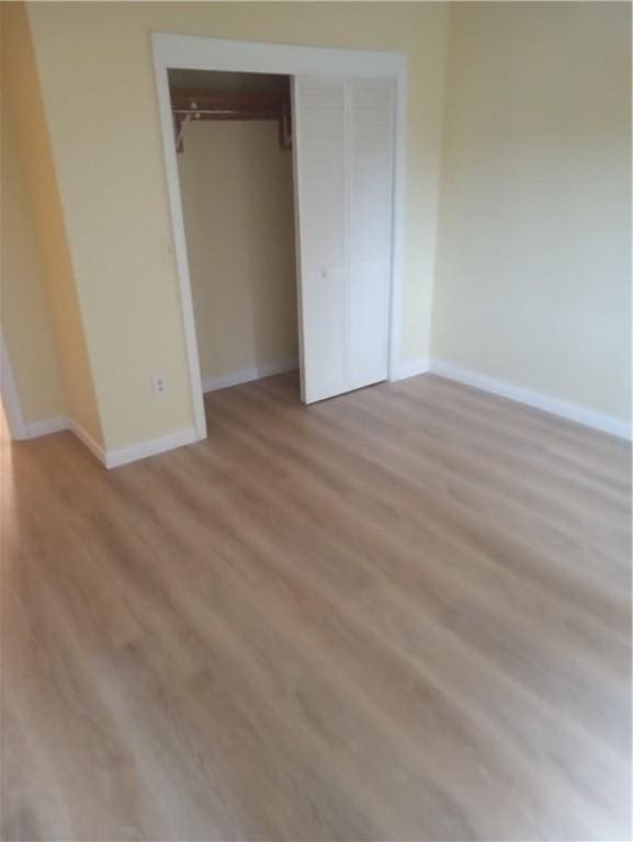 510 Child St Unit 106C, Warren, RI 02885 - unfurnished bedroom featuring light wood-style floors and a closet