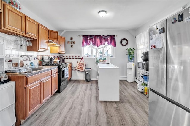 222 Pavilion Ave, Providence, RI 02905 - kitchen featuring appliances with stainless steel finishes, brown cabinetry, light wood finished floors, backsplash, and under cabinet range hood