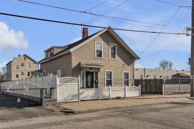 222 Pavilion Ave, Providence, RI 02905 - view of front of home with a gate, a chimney, and a fenced front yard