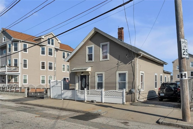222 Pavilion Ave, Providence, RI 02905 - view of front of home with a chimney, a fenced front yard, and a gate