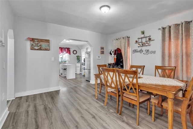 222 Pavilion Ave, Providence, RI 02905 - dining area featuring arched walkways and light wood-style flooring