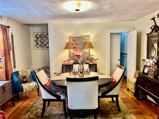 27 Highland St, Cranston, RI 02920 - dining area featuring a textured ceiling and wood finished floors
