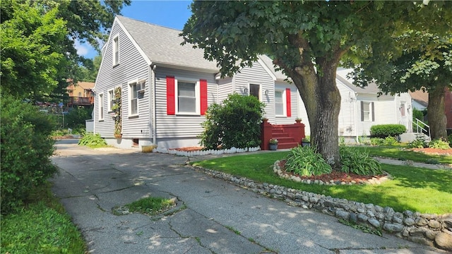 788 Cass Ave, Woonsocket, RI 02895 - obstructed view of property featuring a shingled roof and a front lawn