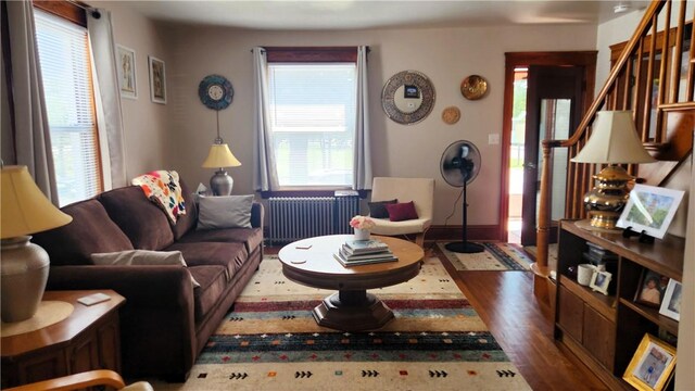 788 Cass Ave, Woonsocket, RI 02895 - living area featuring radiator, wood finished floors, and stairs