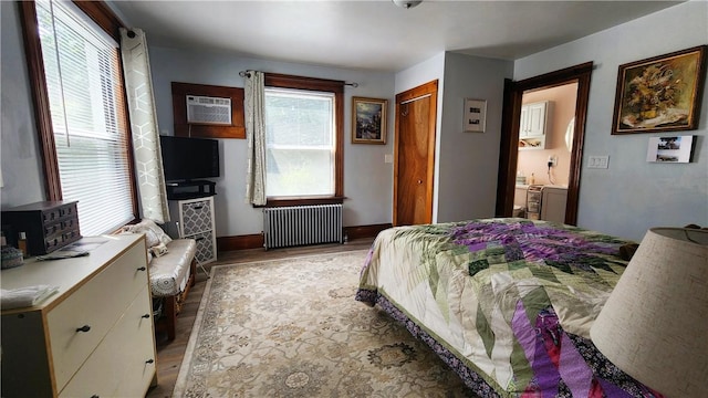 788 Cass Ave, Woonsocket, RI 02895 - bedroom with radiator, light wood-type flooring, and an AC wall unit