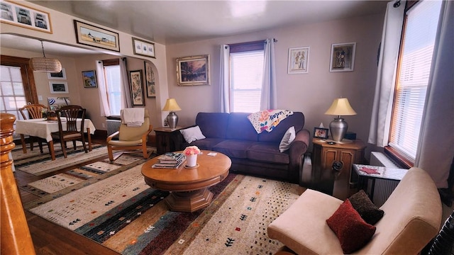 788 Cass Ave, Woonsocket, RI 02895 - living area with plenty of natural light, arched walkways, and wood finished floors