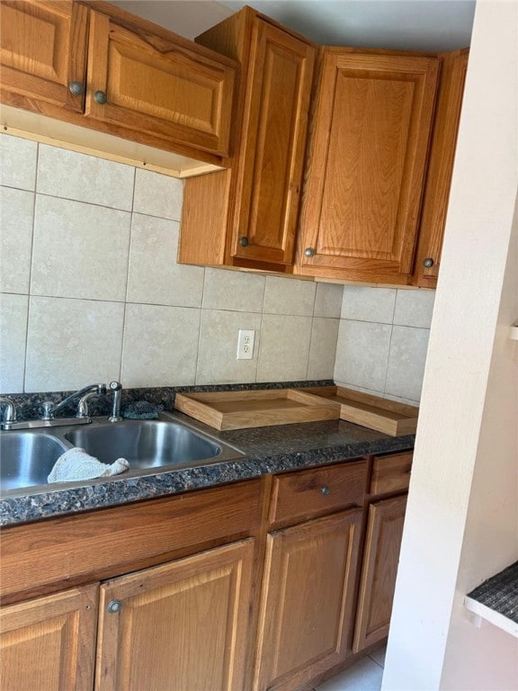 282 Oxford St, Providence, RI 02905 - kitchen with decorative backsplash, brown cabinetry, and dark stone countertops