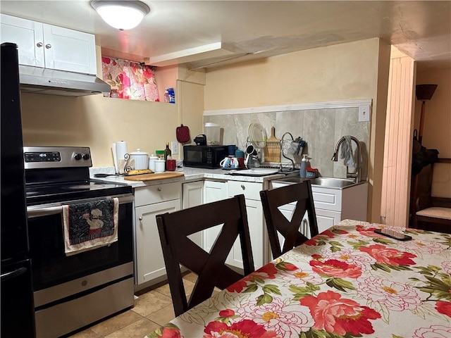 282 Oxford St, Providence, RI 02905 - kitchen with black appliances, ventilation hood, light countertops, and white cabinets