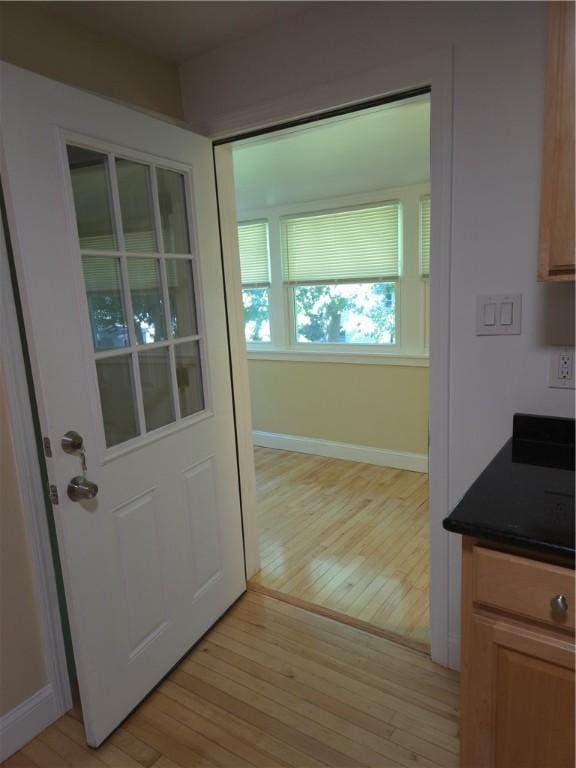 7 Edge St, West Warwick, RI 02893 - doorway with light wood-style flooring and baseboards