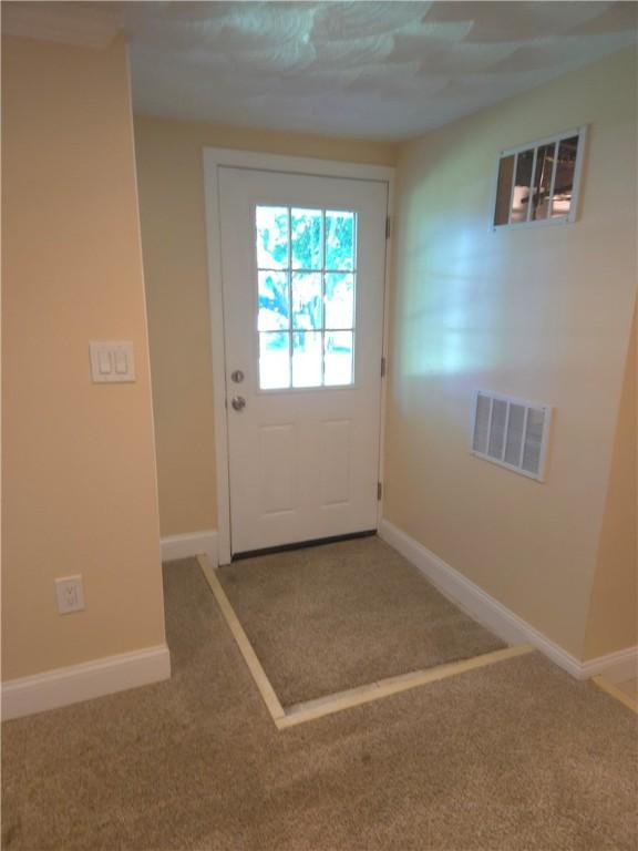 7 Edge St, West Warwick, RI 02893 - doorway to outside with carpet floors