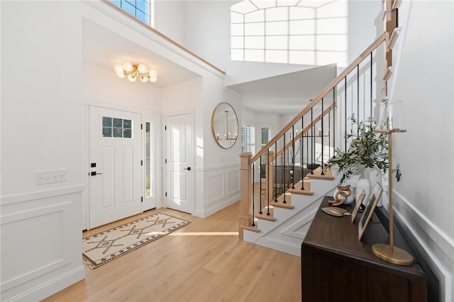 3 Kelsey Eden Way, Cumberland, RI 02864 - entrance foyer with a decorative wall, wood finished floors, stairway, wainscoting, and a high ceiling