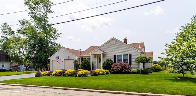 136 Woodward Rd, Providence, RI 02904 - view of front of home with concrete driveway, a front yard, a chimney, and a garage