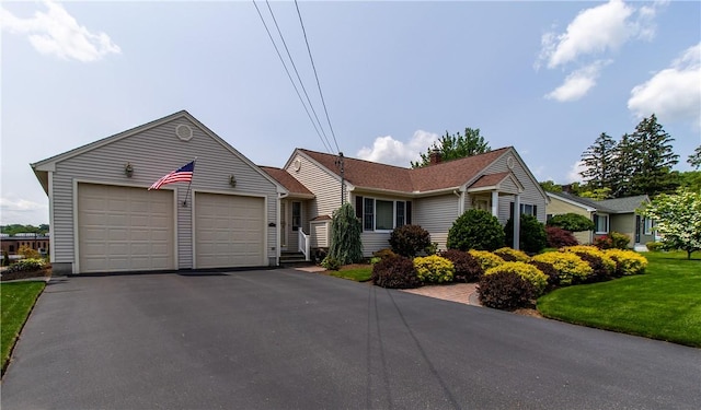 136 Woodward Rd, Providence, RI 02904 - ranch-style house featuring a garage, driveway, and a front lawn
