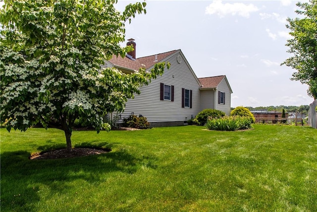 136 Woodward Rd, Providence, RI 02904 - view of side of property featuring a chimney, a lawn, and roof with shingles