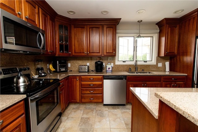 136 Woodward Rd, Providence, RI 02904 - kitchen featuring stainless steel appliances, light stone counters, backsplash, hanging light fixtures, and recessed lighting