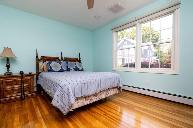 136 Woodward Rd, Providence, RI 02904 - bedroom featuring wood finished floors, a baseboard heating unit, and ceiling fan