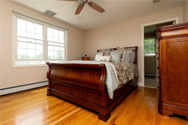 136 Woodward Rd, Providence, RI 02904 - bedroom with a baseboard heating unit, light wood finished floors, baseboard heating, and a ceiling fan