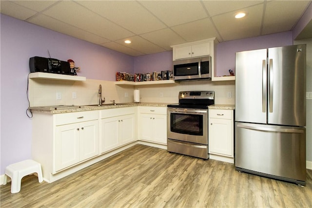 136 Woodward Rd, Providence, RI 02904 - kitchen featuring stainless steel appliances, open shelves, a paneled ceiling, tasteful backsplash, and light wood finished floors