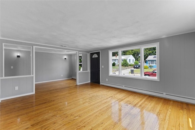 22 Hillcrest Dr, West Warwick, RI 02893 - unfurnished room with wood finished floors, a baseboard heating unit, a decorative wall, and baseboard heating