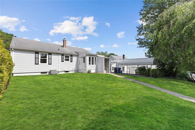 22 Hillcrest Dr, West Warwick, RI 02893 - rear view of house with a lawn, a carport, and a chimney