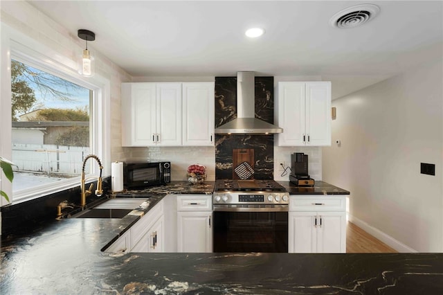 6 Flanders St, Johnston, RI 02919 - kitchen with wall chimney exhaust hood, stainless steel stove, black microwave, decorative backsplash, and white cabinetry