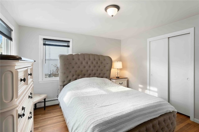 6 Flanders St, Johnston, RI 02919 - bedroom featuring a baseboard radiator, light wood-style floors, and a closet