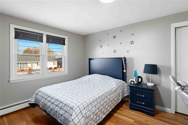 6 Flanders St, Johnston, RI 02919 - bedroom featuring a baseboard heating unit and wood finished floors