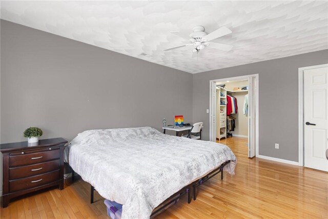 29 Gilcrest Dr, West Warwick, RI 02893 - bedroom featuring light wood-style floors, a walk in closet, a closet, and ceiling fan