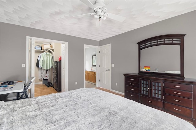 29 Gilcrest Dr, West Warwick, RI 02893 - bedroom with ensuite bath, wood finished floors, a walk in closet, a ceiling fan, and a closet