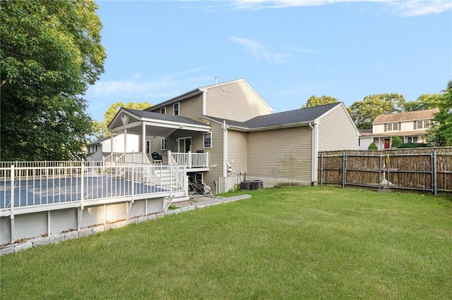 29 Gilcrest Dr, West Warwick, RI 02893 - back of property featuring a fenced backyard, stairway, a deck, and a pool