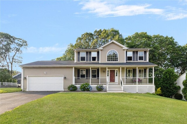29 Gilcrest Dr, West Warwick, RI 02893 - colonial house featuring driveway, covered porch, an attached garage, and a front lawn