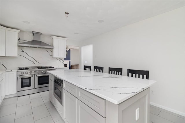 29 Gilcrest Dr, West Warwick, RI 02893 - kitchen with appliances with stainless steel finishes, wall chimney exhaust hood, a center island, light tile patterned floors, and light stone countertops