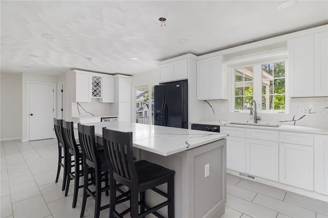 29 Gilcrest Dr, West Warwick, RI 02893 - kitchen featuring black fridge with ice dispenser, backsplash, a center island, healthy amount of natural light, and recessed lighting