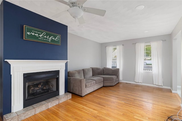 29 Gilcrest Dr, West Warwick, RI 02893 - living room featuring light wood-style flooring, a tiled fireplace, ceiling fan, and recessed lighting
