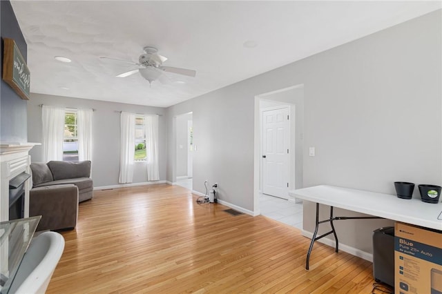 29 Gilcrest Dr, West Warwick, RI 02893 - living room with light wood finished floors, a ceiling fan, and a fireplace
