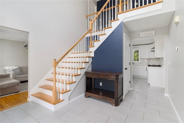29 Gilcrest Dr, West Warwick, RI 02893 - staircase with tile patterned floors and baseboards