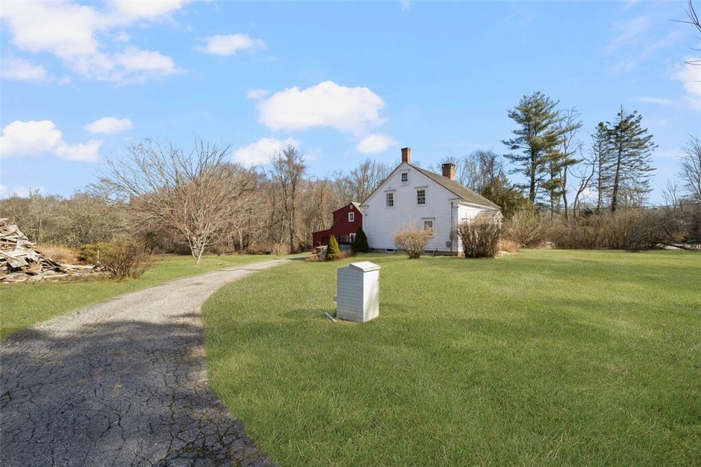 66 Old Danielson Pike, Foster, RI 02825 - view of home's exterior featuring a chimney and a lawn