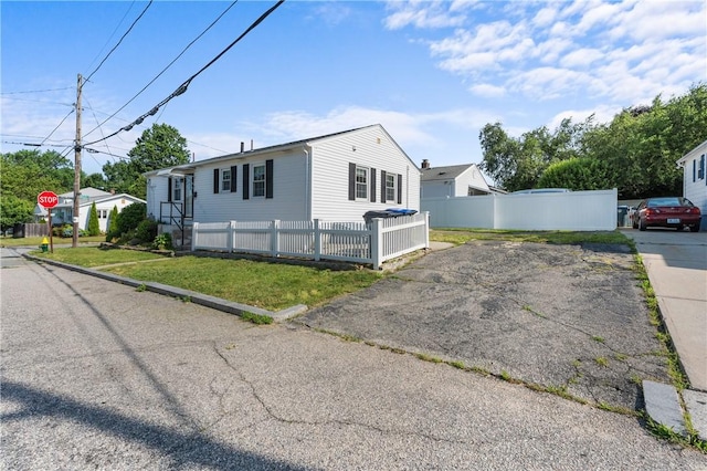 59 Waite St, Providence, RI 02908 - view of front of property with a fenced front yard and driveway
