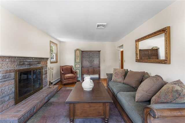 59 Waite St, Providence, RI 02908 - living area featuring a fireplace, a baseboard radiator, and wood finished floors