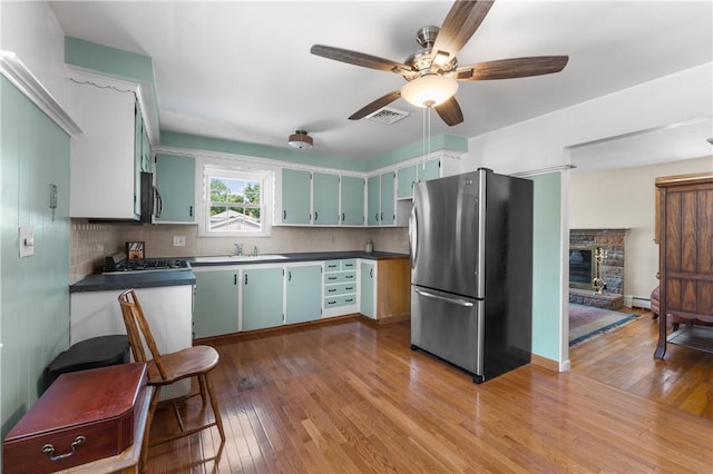 59 Waite St, Providence, RI 02908 - kitchen featuring freestanding refrigerator, hardwood / wood-style flooring, dark countertops, and a ceiling fan
