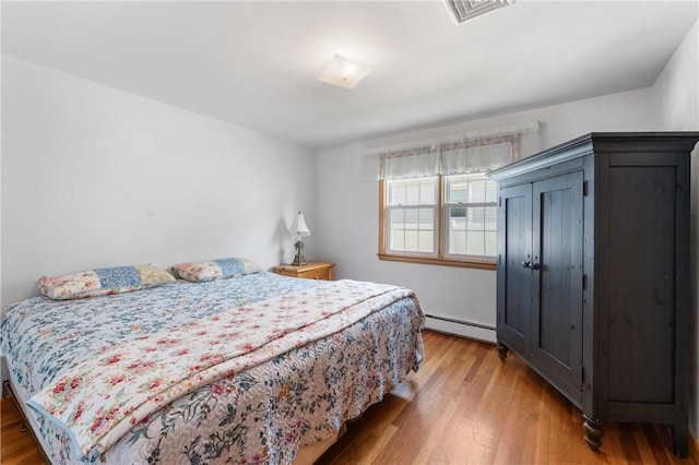 59 Waite St, Providence, RI 02908 - bedroom with a baseboard radiator and wood finished floors