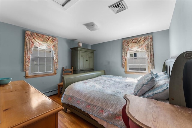 59 Waite St, Providence, RI 02908 - bedroom featuring a baseboard heating unit and wood finished floors