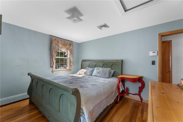59 Waite St, Providence, RI 02908 - bedroom with a baseboard heating unit, wood finished floors, and attic access
