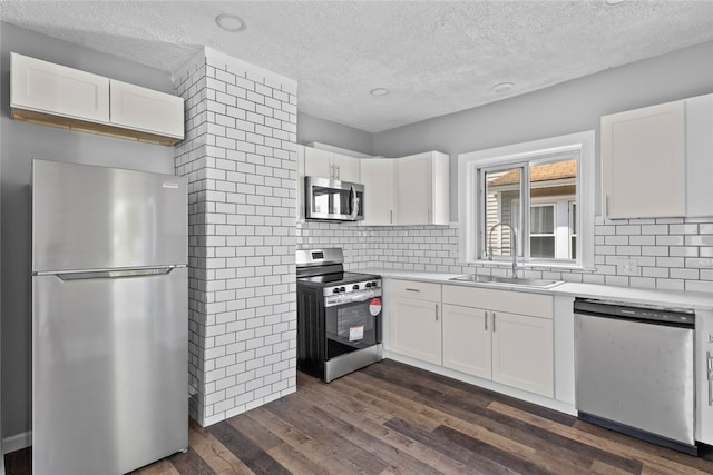 33 Marion Ave, Providence, RI 02905 - kitchen featuring stainless steel appliances, a textured ceiling, white cabinets, dark wood finished floors, and light countertops