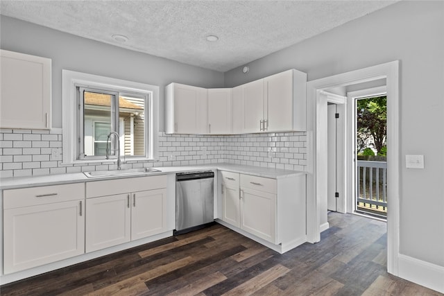 33 Marion Ave, Providence, RI 02905 - kitchen with stainless steel dishwasher, light countertops, white cabinetry, backsplash, and a textured ceiling