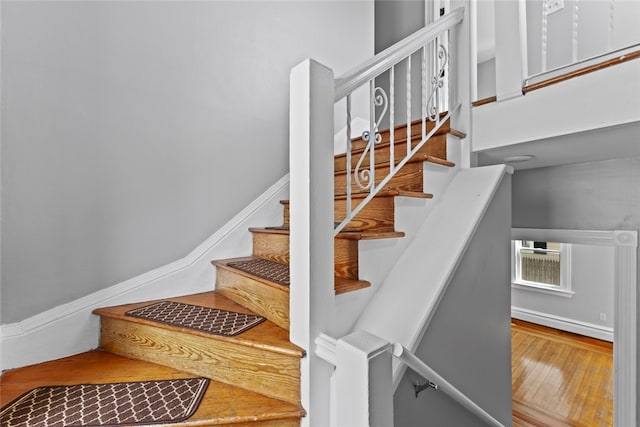 33 Marion Ave, Providence, RI 02905 - stairs with a baseboard heating unit and wood finished floors