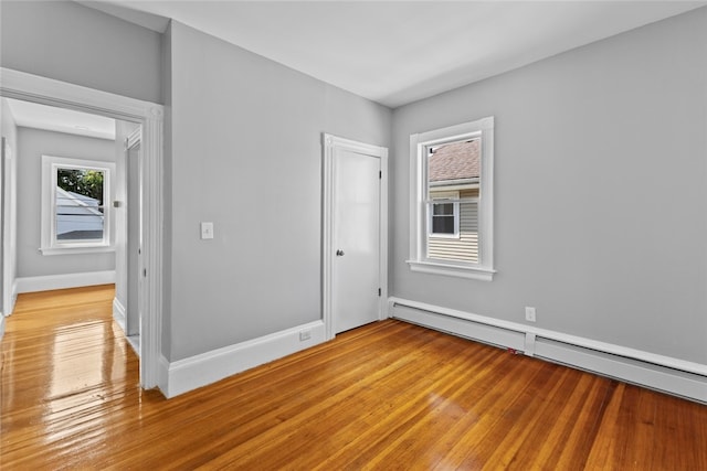 33 Marion Ave, Providence, RI 02905 - empty room featuring a baseboard heating unit and light wood finished floors